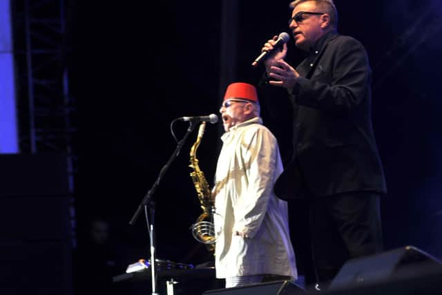Lee on stage with the Nutty Boys, lead singer Suggs looming large on the big screen