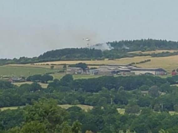 A helicopter tackles a new blaze at Healey Nab. Photo: @geogphotograph