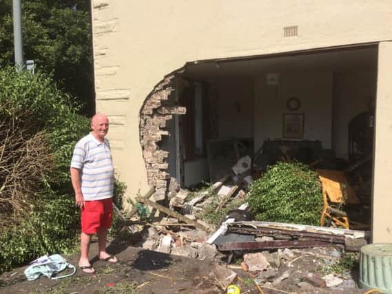 Tony Ross surveys the damage to his destroyed home after a car crashed into it.