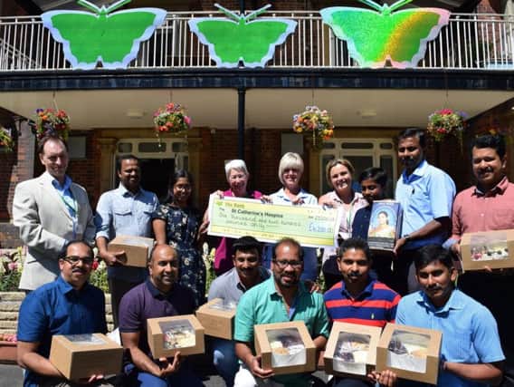Members of Keralite hand over the proceeds and cakes to Emma Jacovelli, head of community engagement at St Catherines Hospice