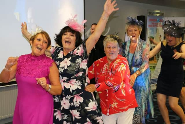 Dancing between races at the Rainbow House Ladies Day