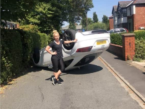 Football freestyler Liv next to her flipped car