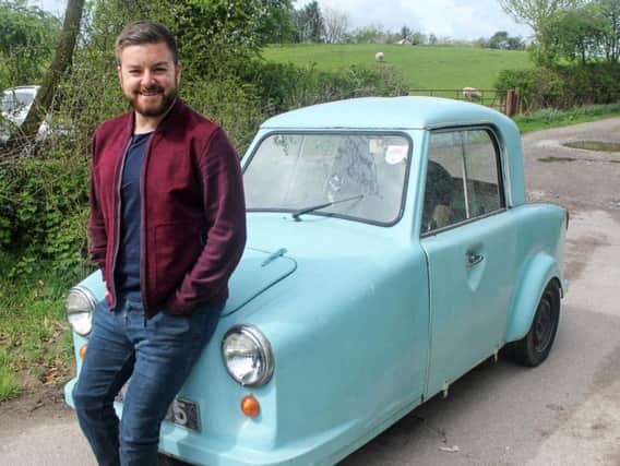 Alex Brooker with an old disability car, one of the features of The NHS: A People's History