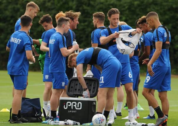 PNE players take a drinks break during a training session at Springfields this week (photo: NEIL CROSS)