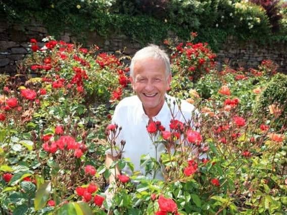 Raymond Smith in his bed of roses in the gardens of White Coppice Farm.