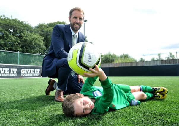Gareth Southgate, the then England U21 Manager with young PNE keeper Stanley Keller, seven, at PlayFootball, Ingol