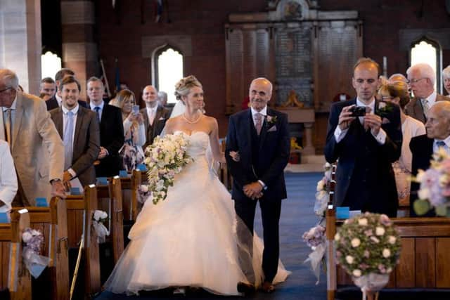 Melissa walks up the aisle with her dad.