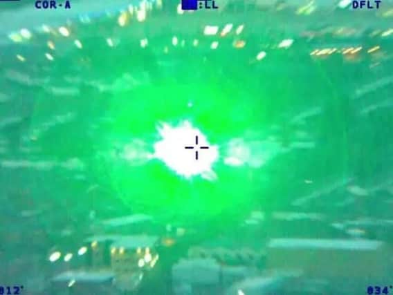 The moment the laser was shone at police helicopter in May