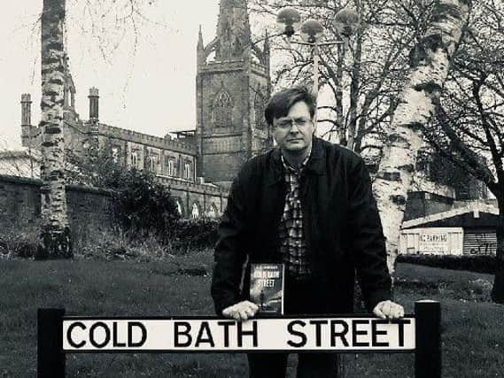 AJ Hartley by the Cold Bath Street sign