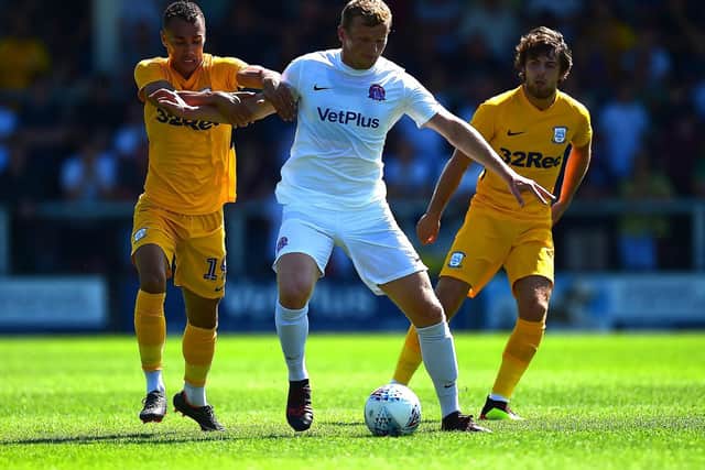 Graham Burke and Ben Pearson gets to grips with AFC Fylde Danny Rowe