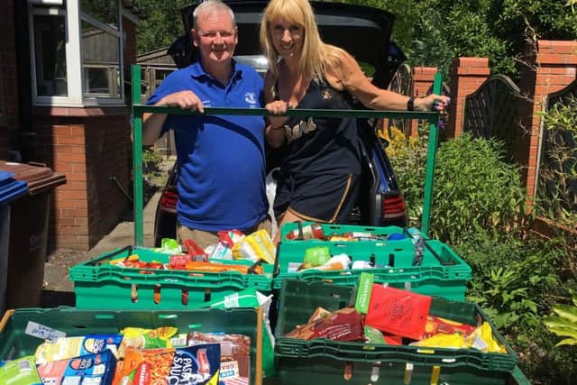 The couple with a trailer load of parcels for the food bank