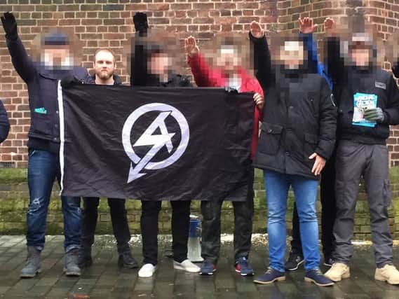 Christopher Lythgoe, 32 with the official National Action logo on a flag. The leader of the banned neo-Nazi group National Action has been jailed for eight years. Photo credit: Greater Manchester Police/PA Wire