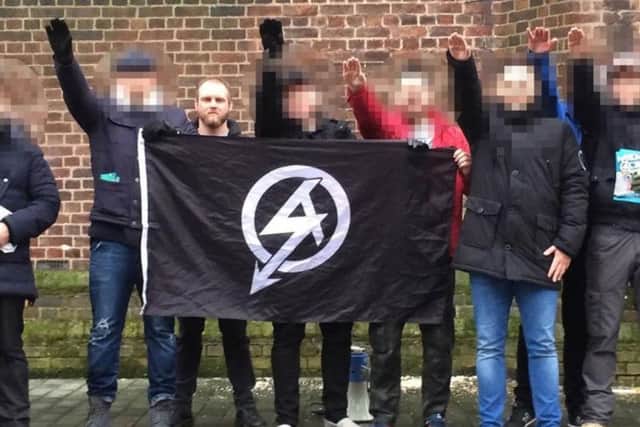 Christopher Lythgoe, 32 with the official National Action logo on a flag. Other faces have been blurred by police