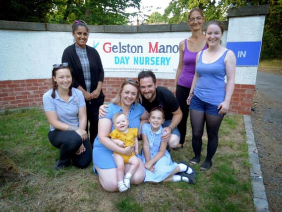 Front, Gelston Manor Nursery owners Laura and Neil Ward with their daughters Freya, one, and Jessica, eight, and behind from left, room leader Fran Purdy, nursery practitioner Aksah Tahir, nursery practitioner Katerina Prakova and deputy room leader Miranda Holt