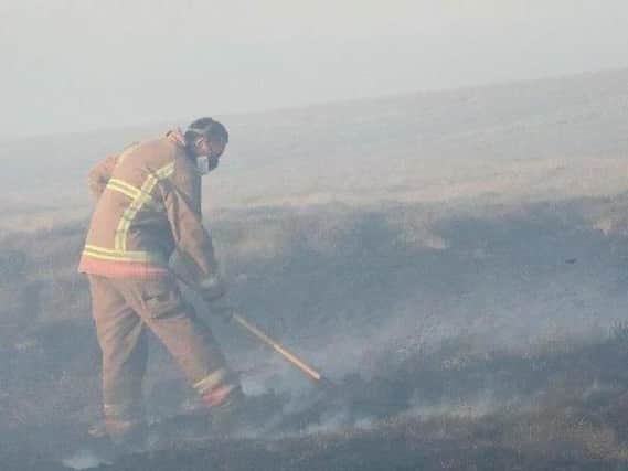 Firefighter battles the blaze at Winter Hill earlier this month.
