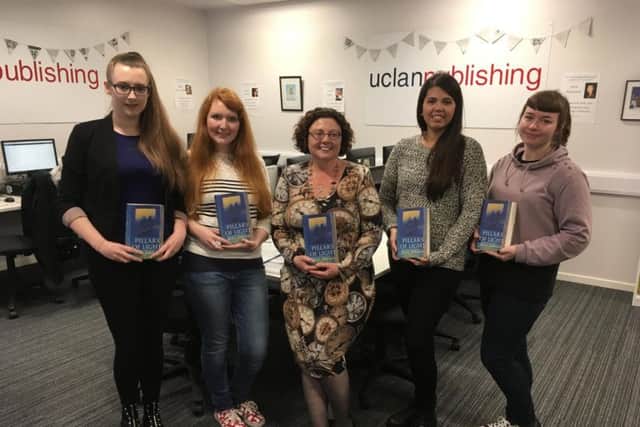 Some of the MA Publishing students and Head of UCLan Publishing Debbie Williams, in the centre, with their Pillars of Light book.