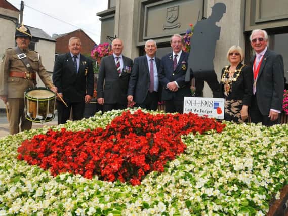From left: Terry Seeds, Frank Liszczyk, Aaron Beaver, Sir Lindsay Hoyle MP, Colin Denby, Mayor of Chorley Margaret Lees and consort Roy Lees, next to the Silent Solider sihouette outside Union Street council offices, Chorley, making 100th anniversary since the end of WW1.