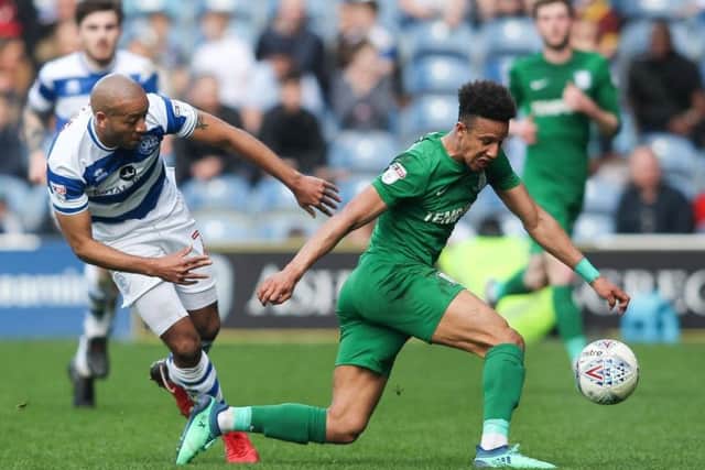 Callum Robinson is challenged by former PNE defender Alex Baptiste in the game at Loftus Road in April