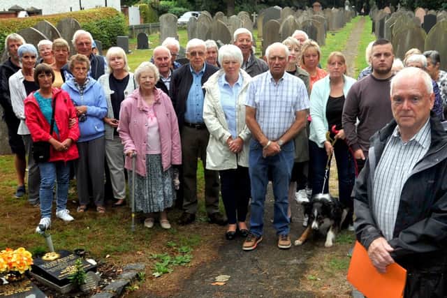 Arnold Gaskell, front right, with relatives of the deceased and members of the community are angry and upset after gravestones have been pushed over, with no warning, due to health and safety, at Croston Cemetery, St Michael and All Angels Churchyard, Croston
