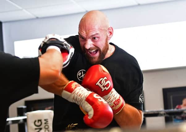 Tyson Fury spars in the ring during a workout at Ricky Hatton's gym