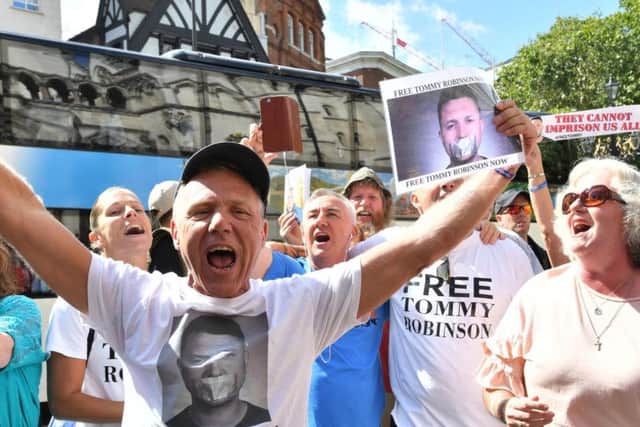 Supporters of Tommy Robinson celebrate outside the Royal Courts of Justice in London