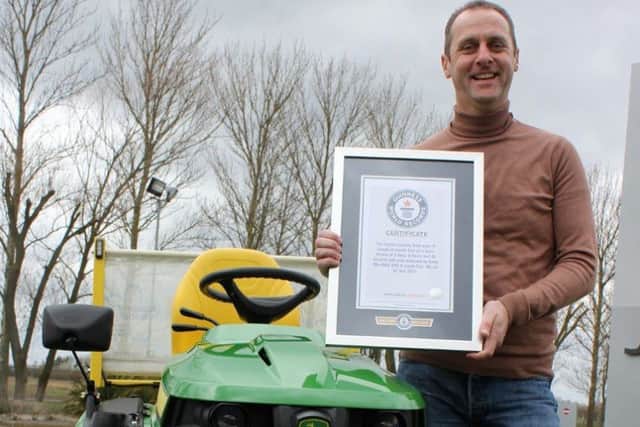 Andy Maxwell shows off his Guinness World Record certificate