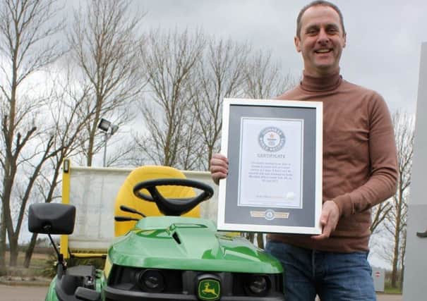 Andy Maxwell shows off his Guinness World Record certificate