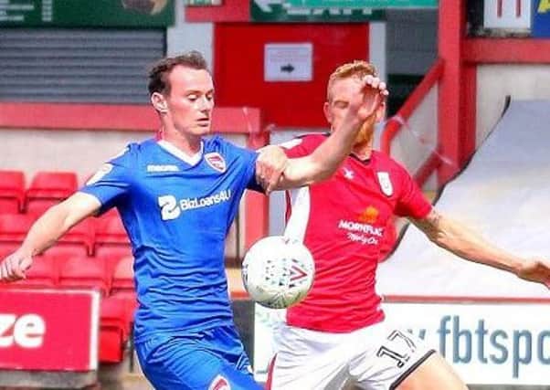 Morecambe's Liam Mandeville battles for the ball at Gresty Road (photo: Mike Williamson)