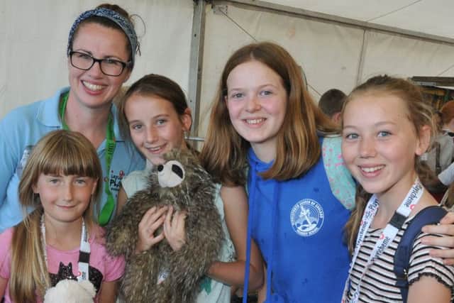 LEP - LEYLAND  02-08-18
Volunteer Emma Cowen, left, with kids aged four to 15 years old,  have fun at Leyland Play Scheme event, organised and run by a team of volunteers, the event was held at Leyland United ground.