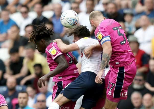 Preston North End's Alan Browne goes up for a header with Queens Park Rangers' Eberechi Eze (left) and Toni Leistner