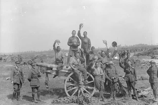 Following the capture of Grevillers by the New Zealand Division, Men of the Royal Garrison Artillery pose beside one of the 4.2 inch guns of a captured battery at Grevillers, 25 August 1918. Note the camouflage netting on the ground, which was designed to prevent the guns from being spotted from the air.  IWM (Q 11243)