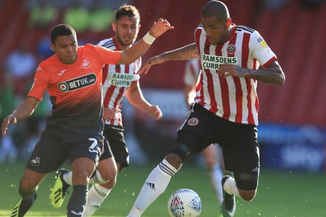 Swansea City's Jefferson Montero battles for the ball with Sheffield United's Leon Clarke last weekend