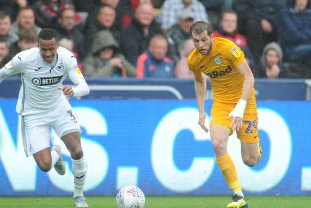 Tom Barkhuizen bursts past Martin Olsson at the Liberty Stadium