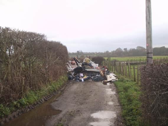 Two men have been slapped with fines after fly-tipping waste on an isolated track in Preston.