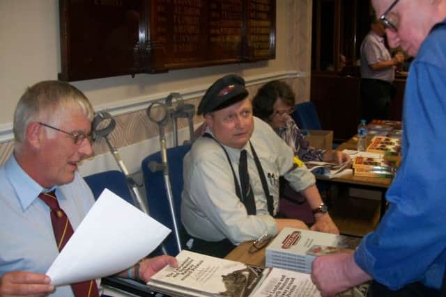 Railway reunion night - Bob Gregson,  joint event organizer, centre, wearing a track-lookoutman uniform, discussing the evening's events at The Leyland and Farington Social Club, Leyland