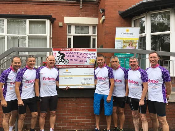 Cyclists present a cheque to CancerHelp