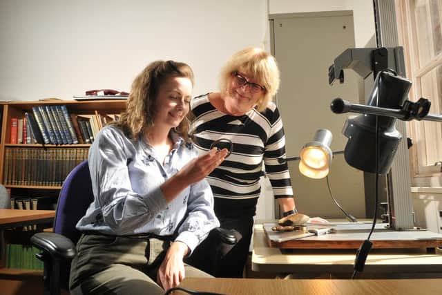Lydia Prosser and Senior Museums Manager Sue Ashworth (right)  take a closer look at a recent find