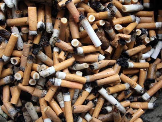 A woman was fined for throwing away a cigarette end
