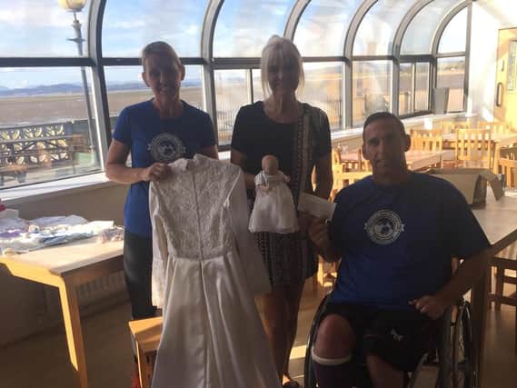 Shaun Gash donates funds to George's Legacy. He is pictured with his wife Dawn and Suzi Casey, who makes the angel gowns for families