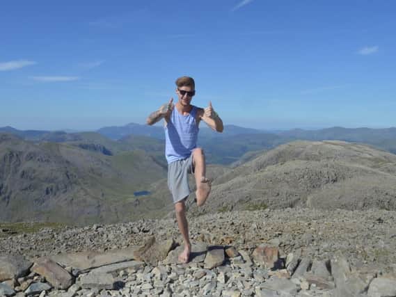 Matthew Strange, 25, completing his climb up Scafell Pike barefoot