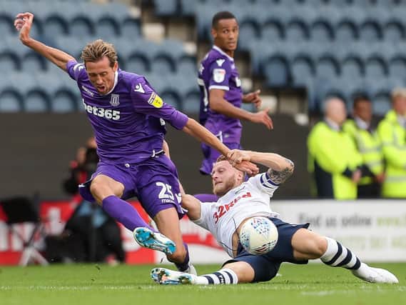 Tom Clarke challenges Peter Crouch in Preston's 2-2 draw with Stoke