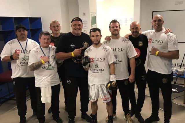 Isaac Lowe celebrates victory in Belfast with his new team including Ricky Hatton, John Fury and Ben Davison.