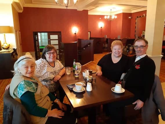 Alan Niven with, left to right, his partner Patricia Barton and newfound sisters  Fran Schultz and Connie Bonsie and, inset, a gift from Connie