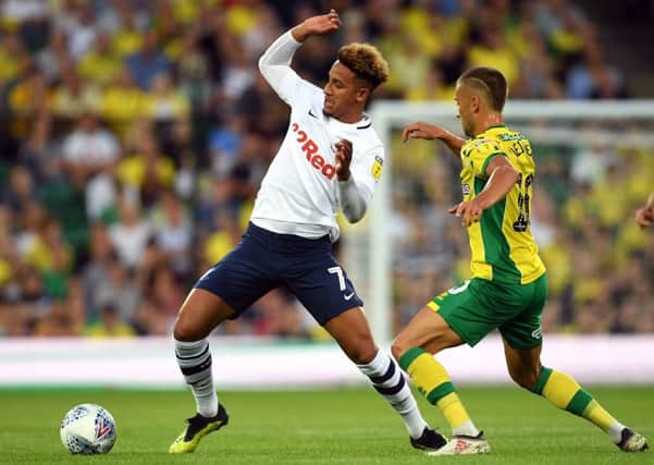 Callum Robinson (left) and Norwich City's Moritz Leitner battle for the ball