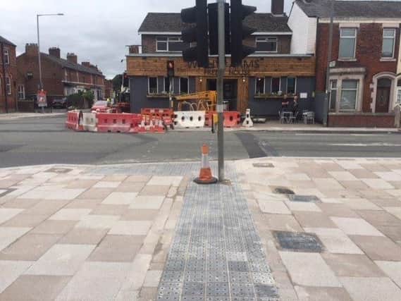 Tactile pavement in Station Road, Bamber Bridge which leads visually impaired pedestrians into a traffic light post.