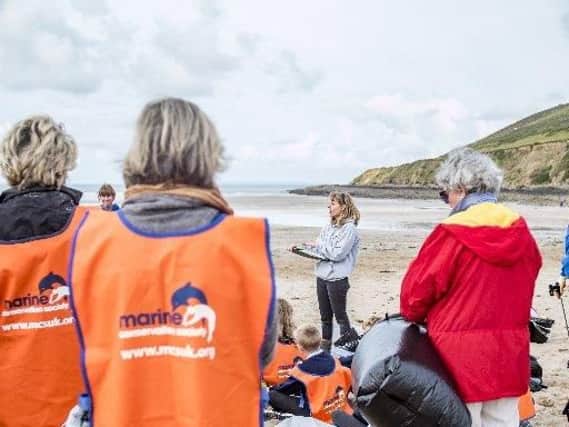 Volunteers are briefed before taking part in the beach clean up