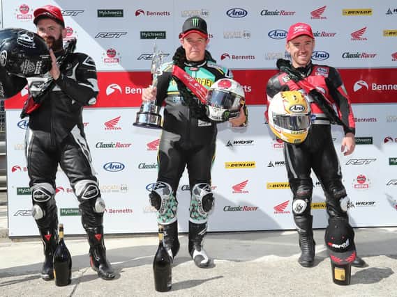 John McGuinness, centre, tops the podium after his victory on Saturday