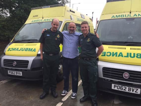 Jamie Johnstone with the paramedics who saved his life - Richard Gornall and Lloyd Tomlinson