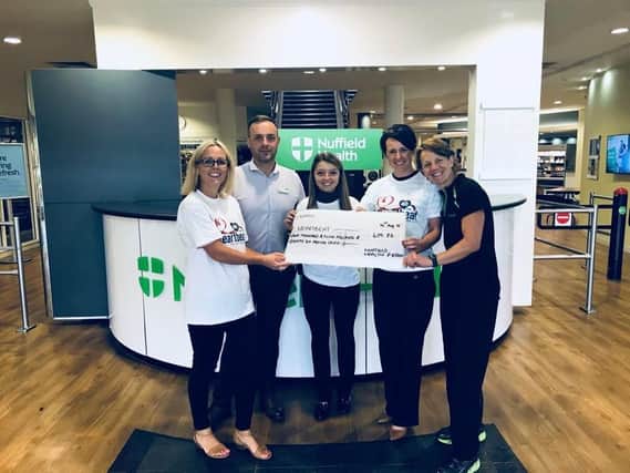 Nuffield gym staff members donate funds to Heartbeat