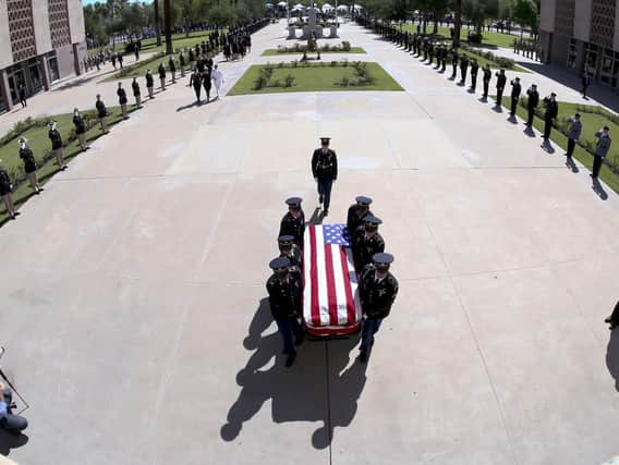 The Arizona National Guard carries the casket of Sen. John McCain, R-Ariz., into a memorial service at the Arizona Capitol in Phoenix